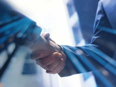 corporate buyer with a handshake over a closed deal