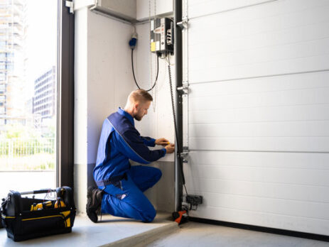 garage door repair man fixing a garage door