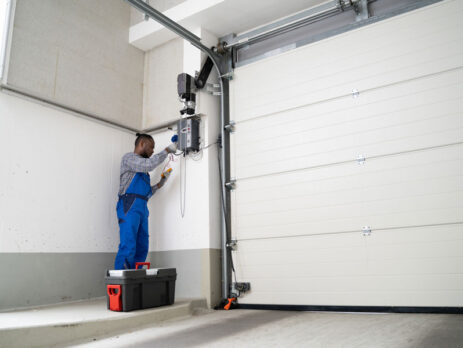 Garage door repair company technician fixing a garge door